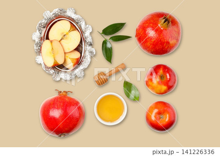 Apples and pomegranates displayed with honey and leaves Apples and pomegranates displayed with honey and leaves 141226336