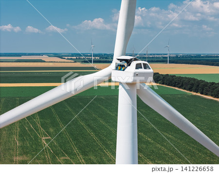 Engineer repairing wind turbine generator from inside the nacelle Engineer repairing wind turbine generator from inside the nacelle 141226658