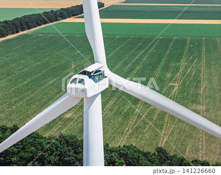 Worker performing routine inspection inside wind turbine nacelle Worker performing routine inspection inside wind turbine nacelle 141226660