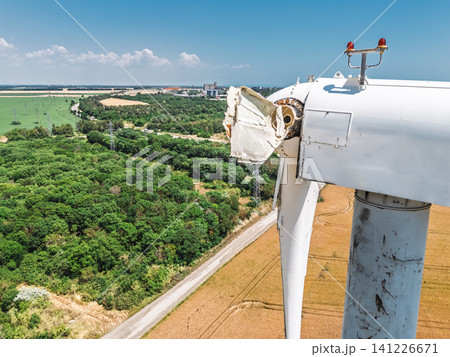 Weathered and broken wind turbine symbolizing energy risk 141226671