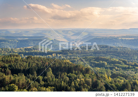 Layers of green mountains and hills in the haze during sunset. Panoramic View of Green hills and Meadow. Layers of green mountains and hills in the haze during sunset. Panoramic View of Green hills and Meadow. 141227139