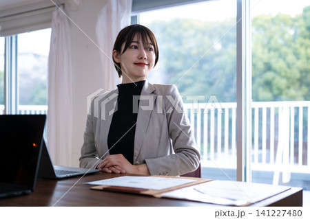 オフィスでデスクに向かう女性 オフィスでデスクに向かう女性 141227480