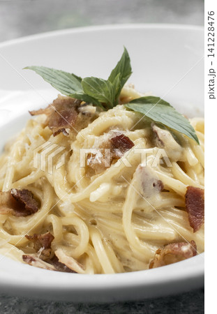 spaghetti carbonara creamy pasta with bacon and chesse on restaurant table spaghetti carbonara creamy pasta with bacon and chesse on restaurant table 141228476