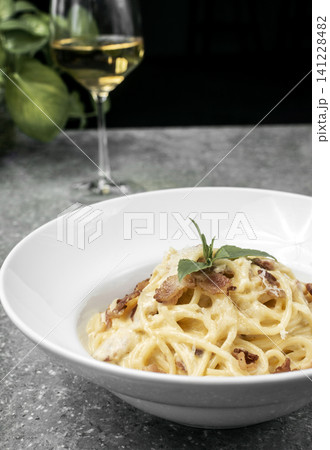 spaghetti carbonara creamy pasta with bacon and chesse on restaurant table 141228482