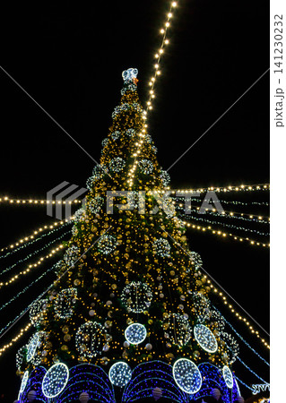 Decorated Christmas tree with multi-colored lights at night Decorated Christmas tree with multi-colored lights at night 141230232