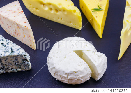 Set of various types of cheese on black slate background Set of various types of cheese on black slate background 141230272