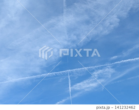 Blue Skies with wispy chemtrail aeroplane lines and fluffy white clouds Blue Skies with wispy chemtrail aeroplane lines and fluffy white clouds 141232462