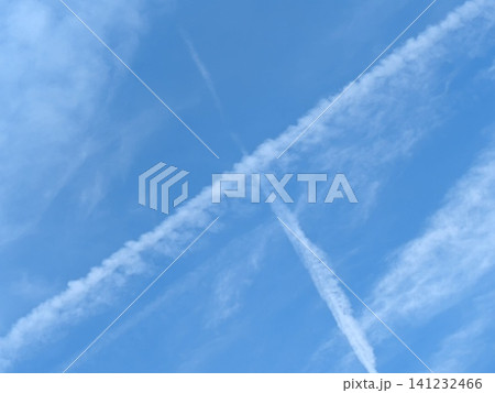 Blue Skies with wispy chemtrail aeroplane lines and fluffy white clouds 141232466