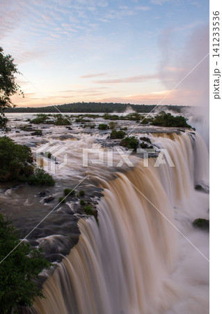 Breathtaking iguazu falls water flows down river landscape in pure nature Breathtaking iguazu falls water flows down river landscape in pure nature 141233536