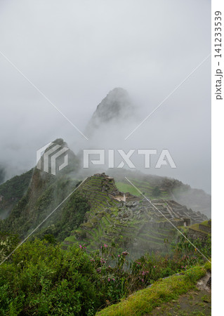 Mysterious fog over machu picchu mountain ruin creates serene mood Mysterious fog over machu picchu mountain ruin creates serene mood 141233539