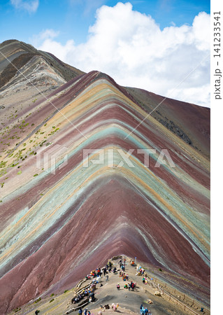 Breathtaking vinicunca rainbow mountain landscape with vibrant colorful peak under blue sky Breathtaking vinicunca rainbow mountain landscape with vibrant colorful peak under blue sky 141233541