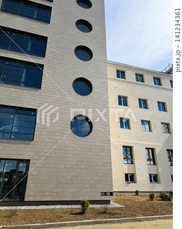 Exterior renovation and wall insulation process, finishing works with scaffolding on house concrete block surface. Exterior renovation and wall insulation process, finishing works with scaffolding on house concrete block surface. 141234361