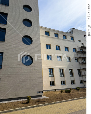 New apartment building and real estate property development, contemporary office corporate exterior with round windows. New apartment building and real estate property development, contemporary office corporate exterior with round windows. 141234362