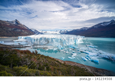Glacier lake icy water mountain landscape frozen turquoise iceberg panoramic view cloudy sky calm water remote wilderness Glacier lake icy water mountain landscape frozen turquoise iceberg panoramic view cloudy sky calm water remote wilderness 141234508