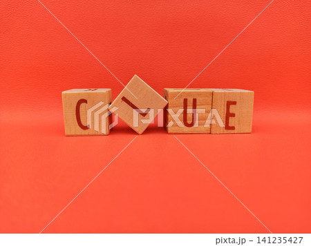 Wooden Blocks Spell Out Clue Against Red Background Wooden Blocks Spell Out Clue Against Red Background 141235427