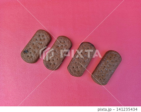 Four Rectangular Chocolate Cookies with Sprinkles on Pink Background 141235434