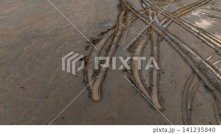 Aerial view wheel tire track on mud, Tire mark imprints on mud vehicles tires footprints transport ground trace or marks textures, wheel treads, Mud terrain. Aerial view wheel tire track on mud, Tire mark imprints on mud vehicles tires footprints transport ground trace or marks textures, wheel treads, Mud terrain. 141235840