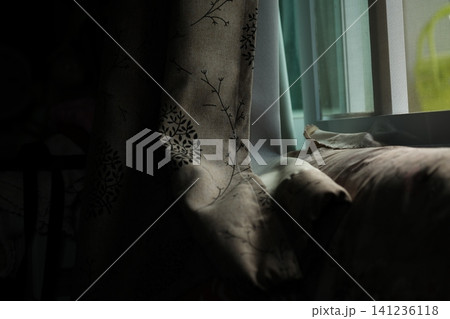 By the window, where soft evening light streams into the bedroom. By the window, where soft evening light streams into the bedroom. 141236118