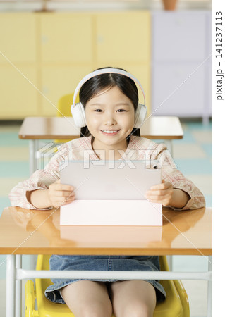 Young student learning online with a laptop in class 141237113