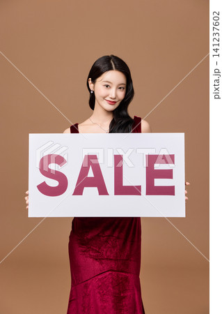 Shopping promotion portrait with a bold sale board 141237602