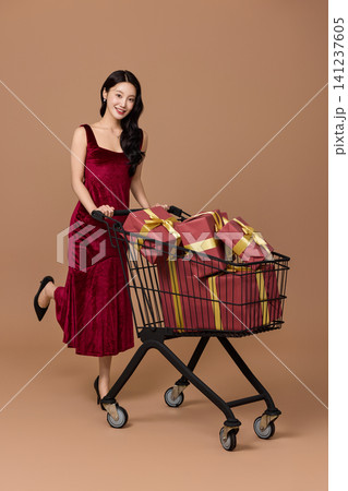 Woman carrying shopping bags after a festive sale Woman carrying shopping bags after a festive sale 141237605