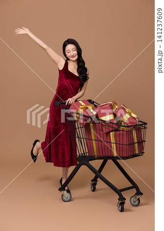 Woman carrying shopping bags after a festive sale Woman carrying shopping bags after a festive sale 141237609