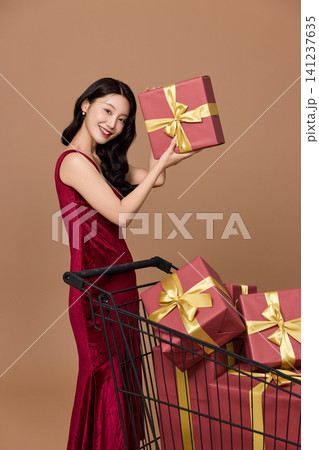 Elegant woman shopping with gift boxes and bags Elegant woman shopping with gift boxes and bags 141237635