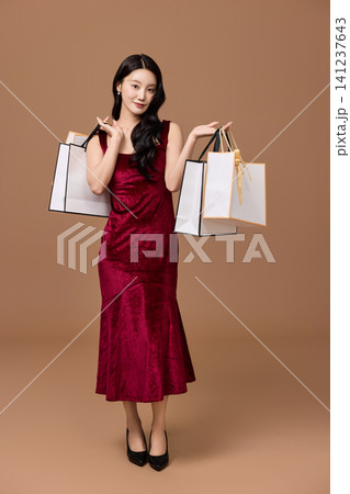 Elegant woman shopping with gift boxes and bags Elegant woman shopping with gift boxes and bags 141237643