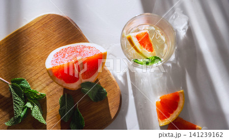 Top view citrus drink with grapefruit slices, mint and premium summer sunlight. Top view citrus drink with grapefruit slices, mint and premium summer sunlight. 141239162
