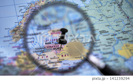 Explore vilnius with a close-up view of a printed map and magnifying glass 141239294
