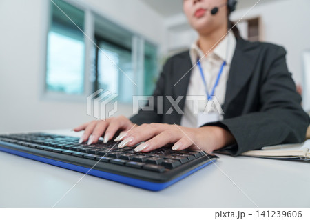 Close up of hands typing on keyboard in office for data entry Close up of hands typing on keyboard in office for data entry 141239606
