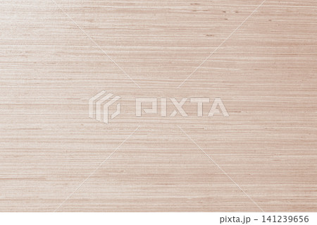 Full frame macro view of a light beige plywood board surface with a fine horizontal natural grain pattern of wooden fibers creating a clean minimalist backdrop 141239656