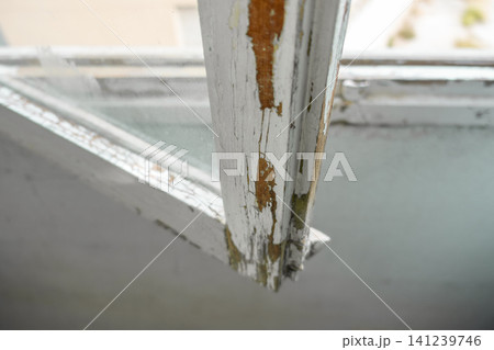 Old Wooden Window Frame with Partially Stripped Paint 141239746