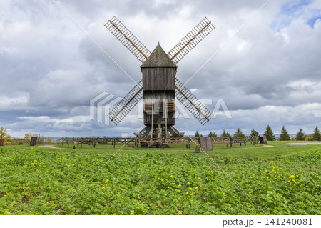 Valmy windmill standing in green field with clouds 141240081
