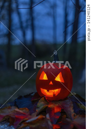 Jack o' lantern glowing in eerie Halloween night 141240124