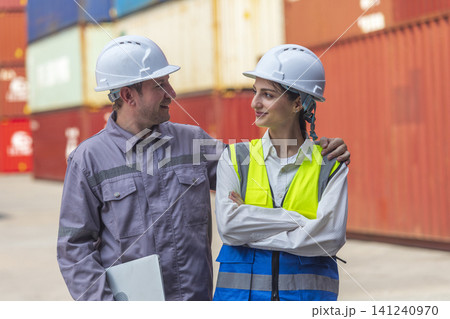 Two engineer standing in front of cargo container with concept of successful in shipping workplace. Two engineer standing in front of cargo container with concept of successful in shipping workplace. 141240970