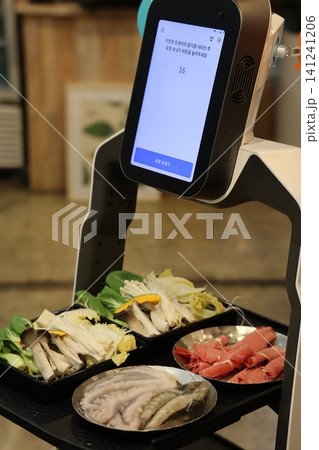 Robot Serving Food in Restaurant Setting Robot Serving Food in Restaurant Setting 141241206