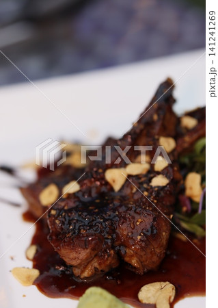 Gourmet Grilled Meat with Sauce and Almonds 141241269