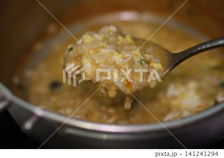 Spoonful of Egg Rice Soup Close-up Spoonful of Egg Rice Soup Close-up 141241294