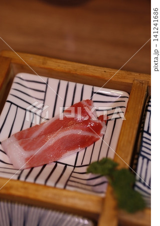 Fresh Sliced Raw Meat on Traditional Plate 141241686