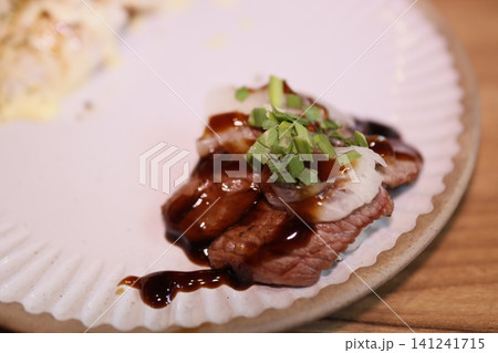 Grilled Steak with Sauce and Chives on Plate Grilled Steak with Sauce and Chives on Plate 141241715