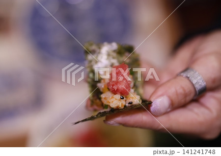 Hand Holding Tuna Nigiri Sushi Close-Up Hand Holding Tuna Nigiri Sushi Close-Up 141241748