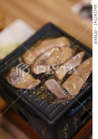 Grilled Meat Slices on Black Plate Grilled Meat Slices on Black Plate 141241749