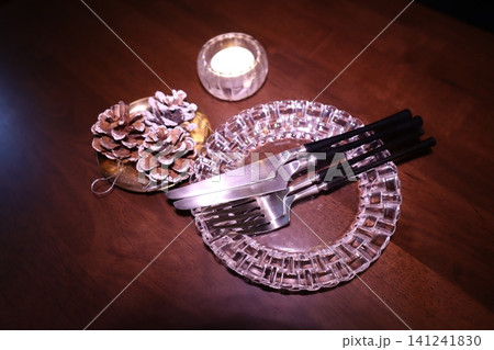 Elegant Table Setting with Pinecones and Candle Elegant Table Setting with Pinecones and Candle 141241830