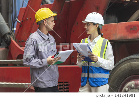 Two engineers discussing project together with construction worker outdoors Two engineers discussing project together with construction worker outdoors 141241981