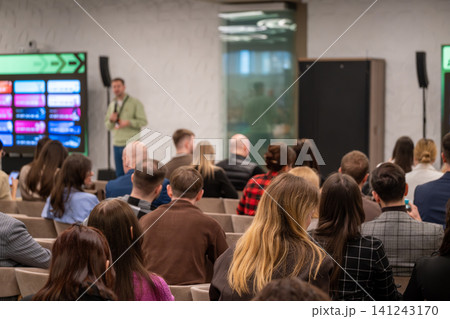 Business conference presentation with engaged audience in modern meeting room listening to speaker Business conference presentation with engaged audience in modern meeting room listening to speaker 141243170