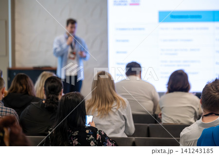 Conference presentation with speaker addressing seated audience during professional seminar and workshop session Conference presentation with speaker addressing seated audience during professional seminar and workshop session 141243185