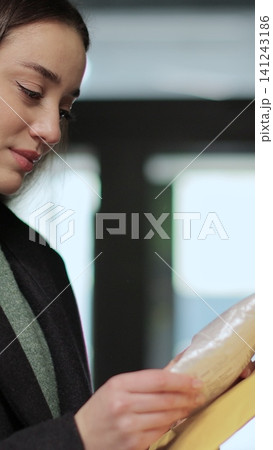 Vertical video Young woman opening and checking mailbox in apartment building. Mail shipping concept. Vertical video Young woman opening and checking mailbox in apartment building. Mail shipping concept. 141243186