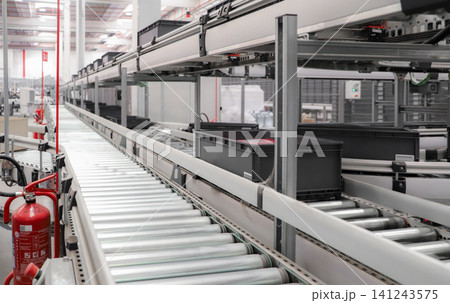 packing line in a logistics warehouse. conveyor belt in a modern production line. Pallet racking 141243575