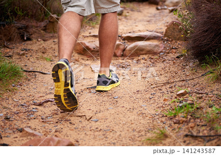 Person, shoes and legs for hiking, exercise and fitness for travel and adventure on vacation. Workout, trekking and training for relax and wellness on ground with rock for outdoor freedom in nature Person, shoes and legs for hiking, exercise and fitness for travel and adventure on vacation. Workout, trekking and training for relax and wellness on ground with rock for outdoor freedom in nature 141243587